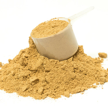 A plastic scoop filled with brown ENZ-Flame™ powder on top of a mound of powder