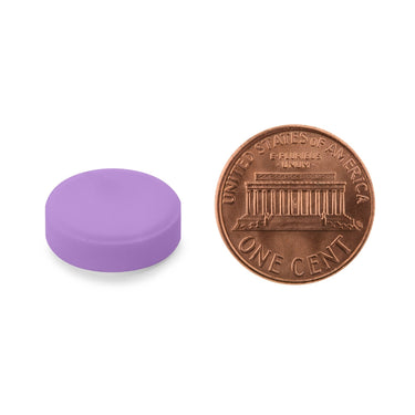 A purple tablet being compared to the size of a penny