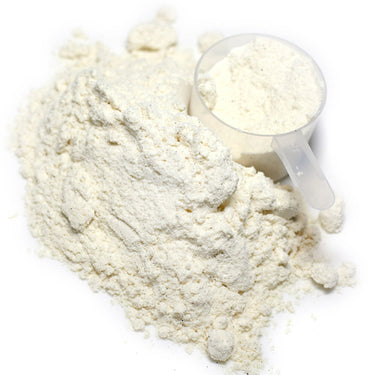 A clear plastic scoop filled with powder next to a mound of Cal-Mag Citrate Powder.