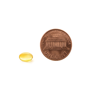 A softgel being compared to the size of a penny